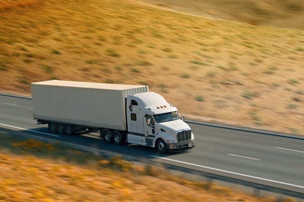 Semi-truck-driving-fast-on-a-country-highway